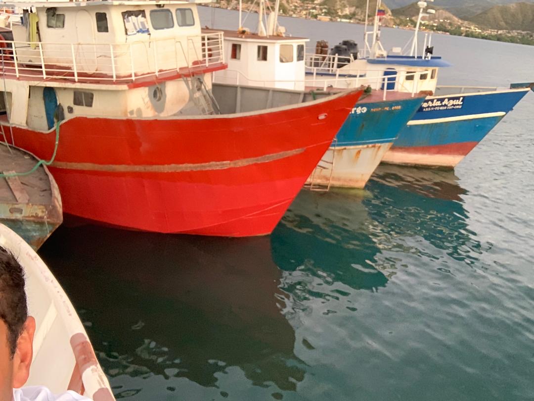 Varias embarcaciones amarradas en puerto, incluida Perla Azul.